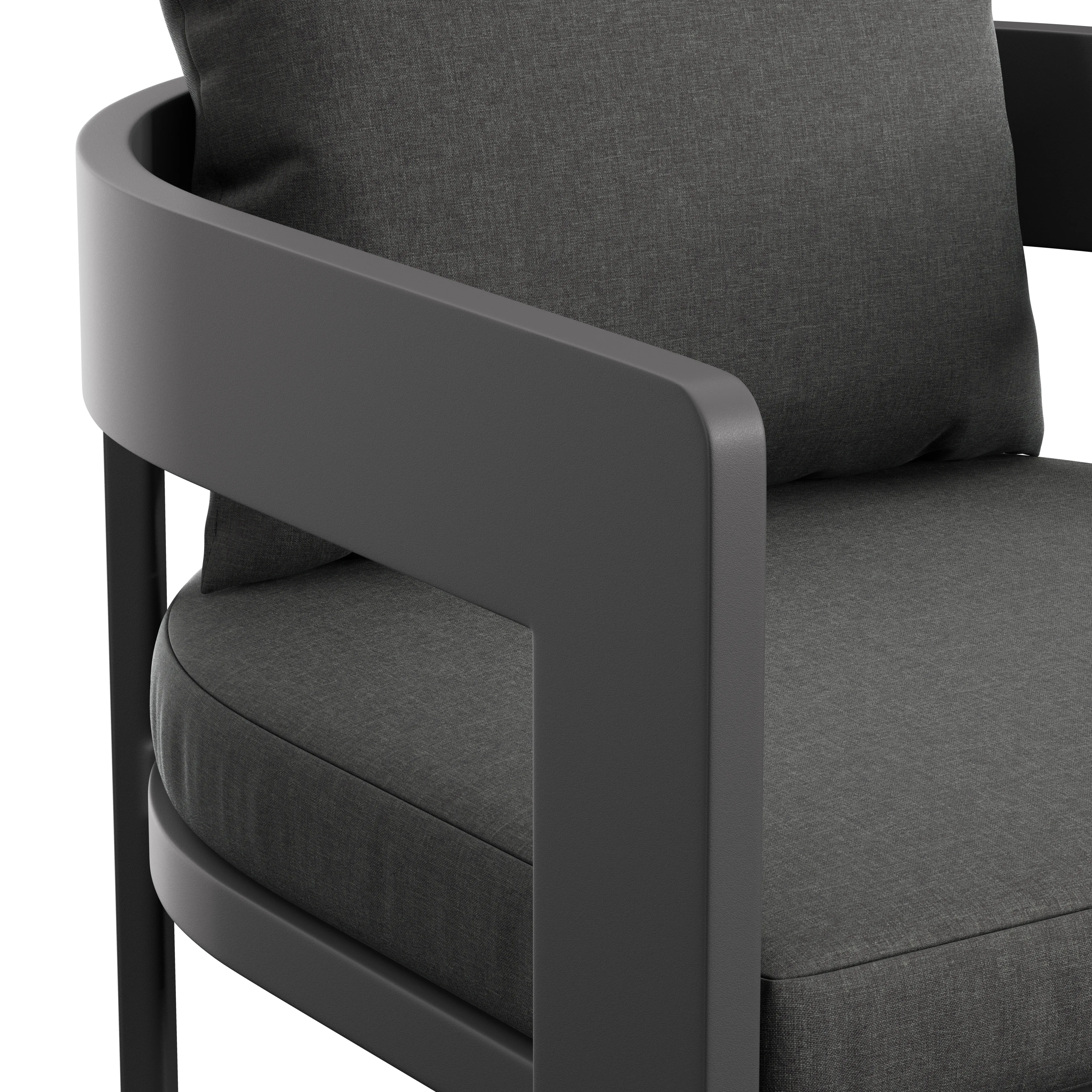 Close-up of a modern dark gray upholstered armchair with rounded armrest and cushioned seat and textured fabric